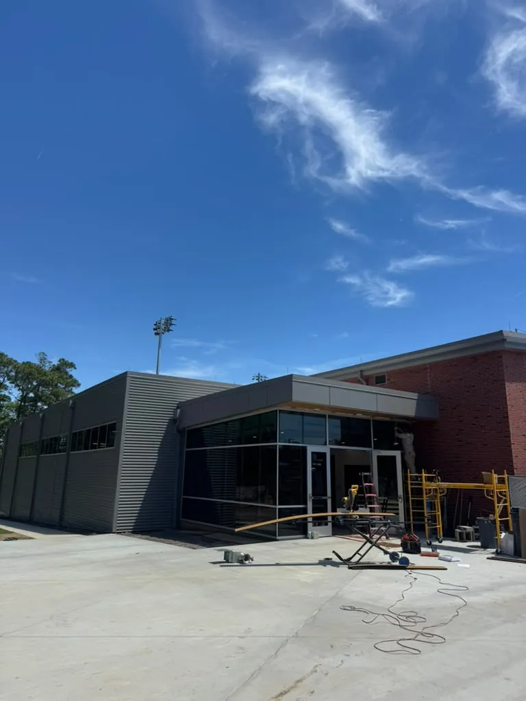 New commercial building with metal wall panels and a glass entrance