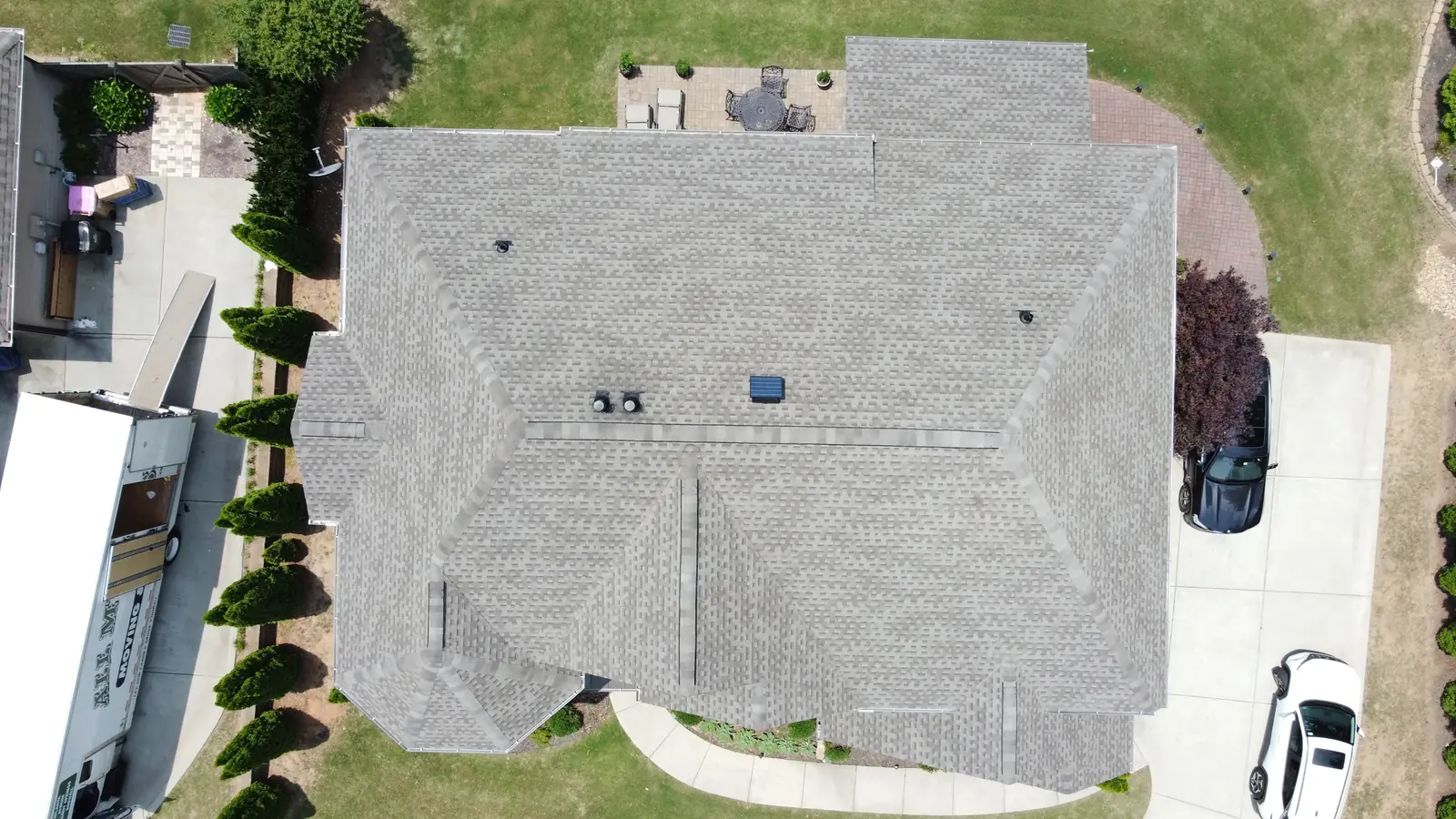 Overhead drone view of a gray shingle roof replacement